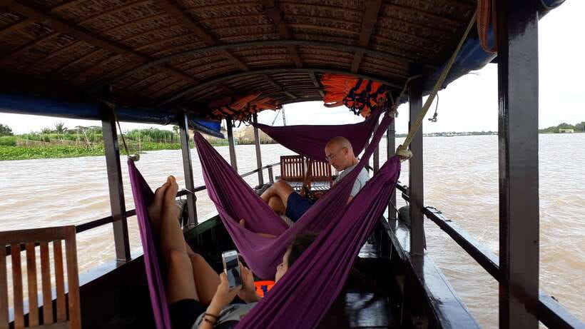 Mekong Day Tour by Car:Cai Be market, Local Island & Cycling - Cái Bè by private boat: candy, honey tea, fruit, and folk music
