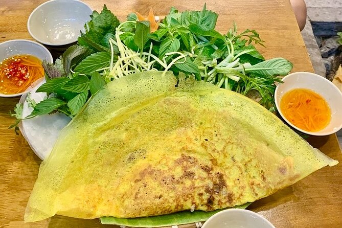 Saigon By Night: Authentic Street Food Scooter Adventure - Scooter-and-food night in District 1: how the evening starts
